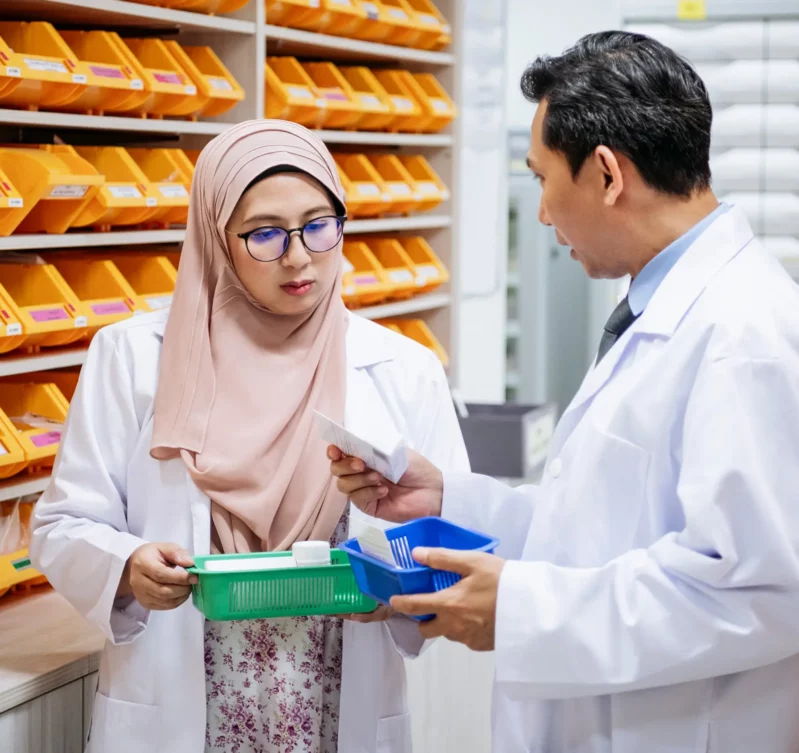 A female and male pharmacist discussing medication